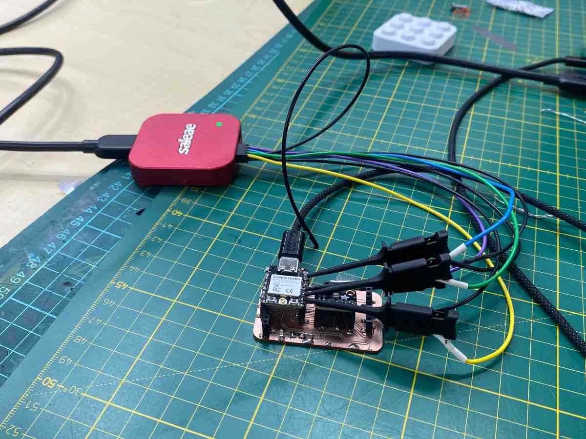 Setup photo showing Saleae Logic Pro 8 connected to the custom PCB with colored probe wires
